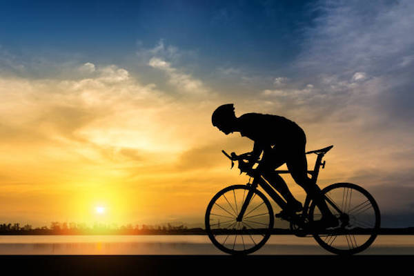 Silhouette of cyclist on the background of beautiful sunset,Silhouette of man ride a bicycle in sunset background.